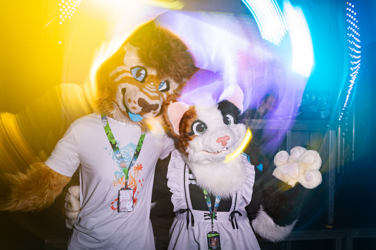 Two fursuiters posing at a SloFluffCon dance