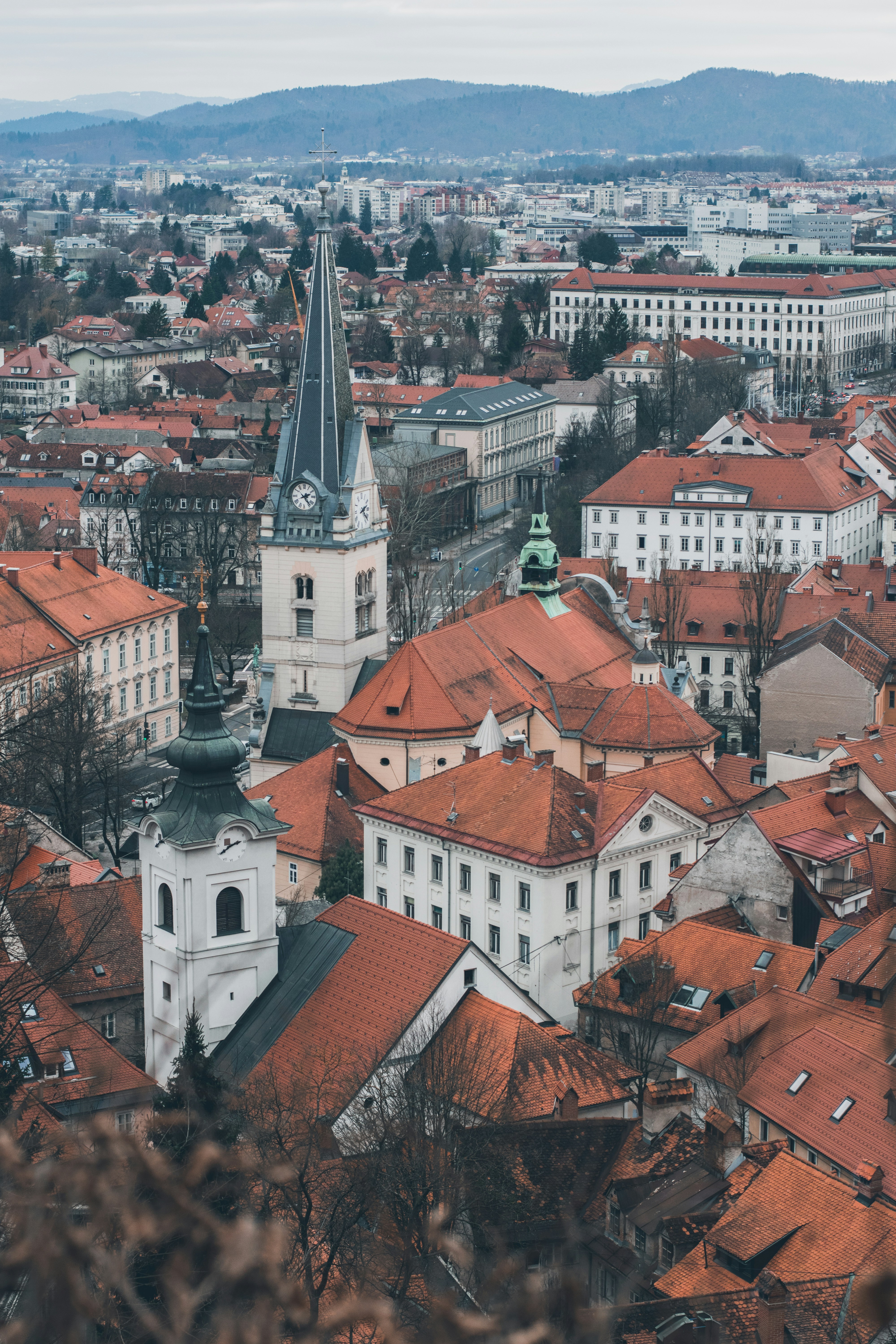 A high view across the rooftops of Ljubljana toward the castle