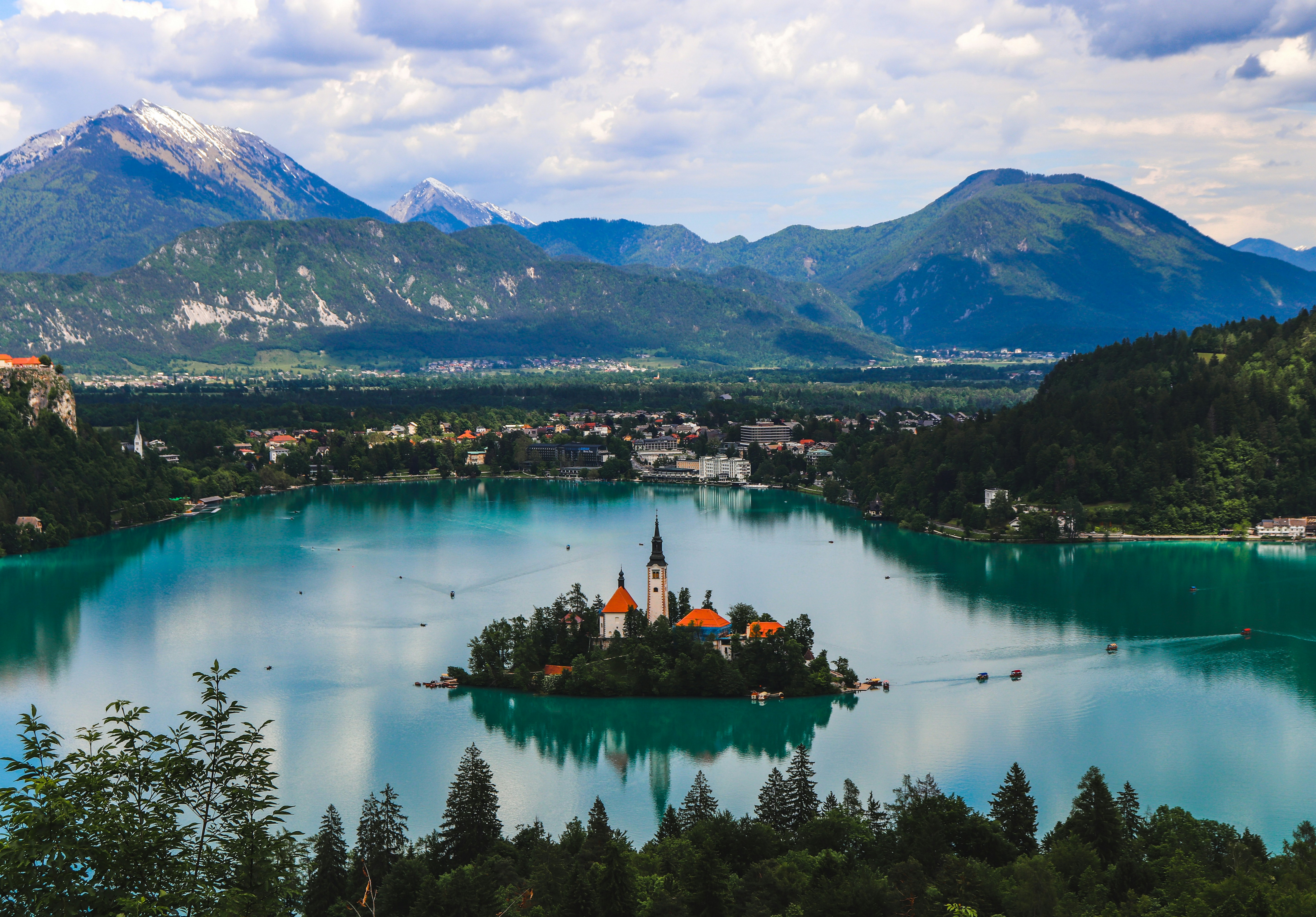 Lake Bled with its island church, framed by green trees and mountains