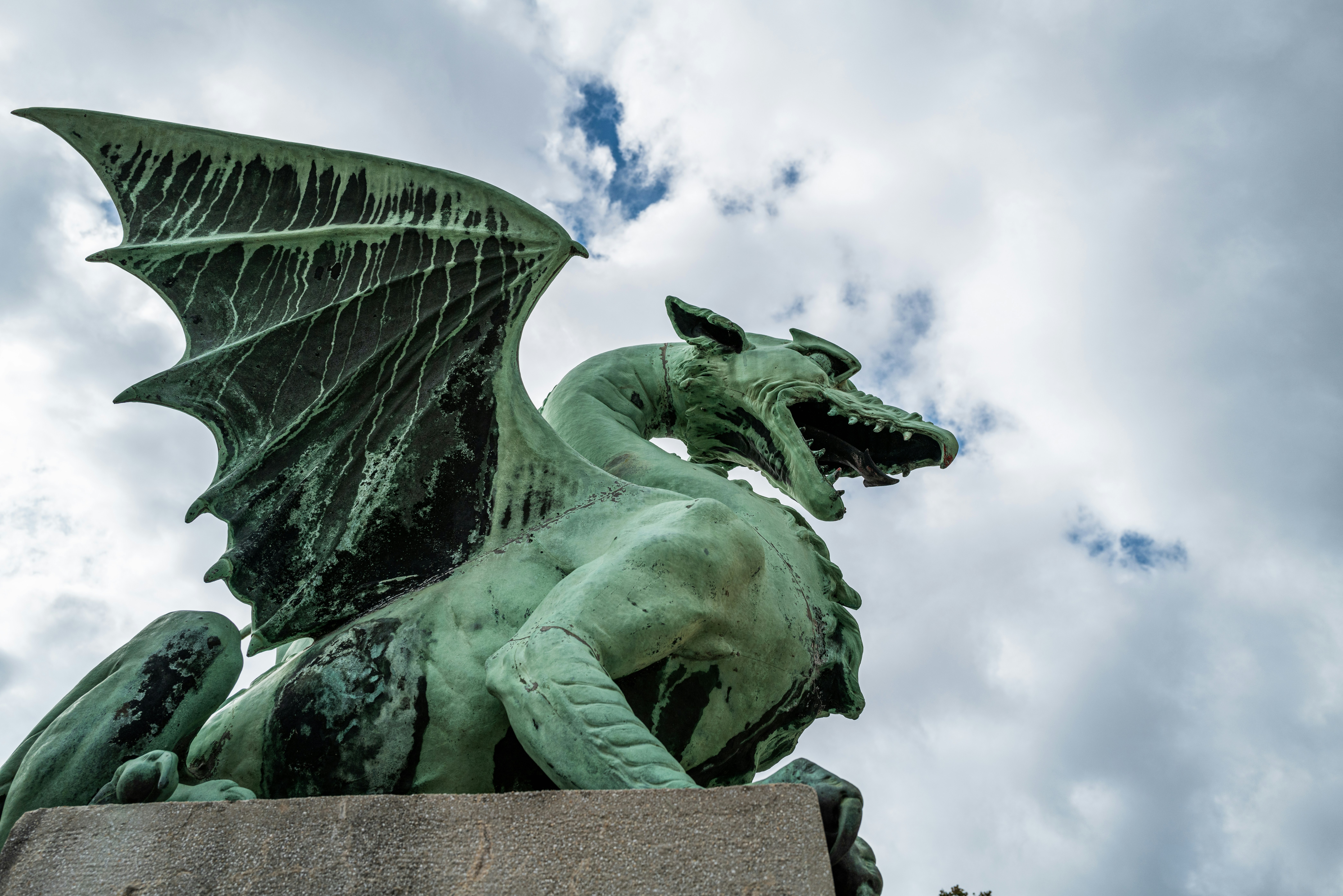 One of the winged copper dragon statues guarding the Dragon Bridge in Ljubljana